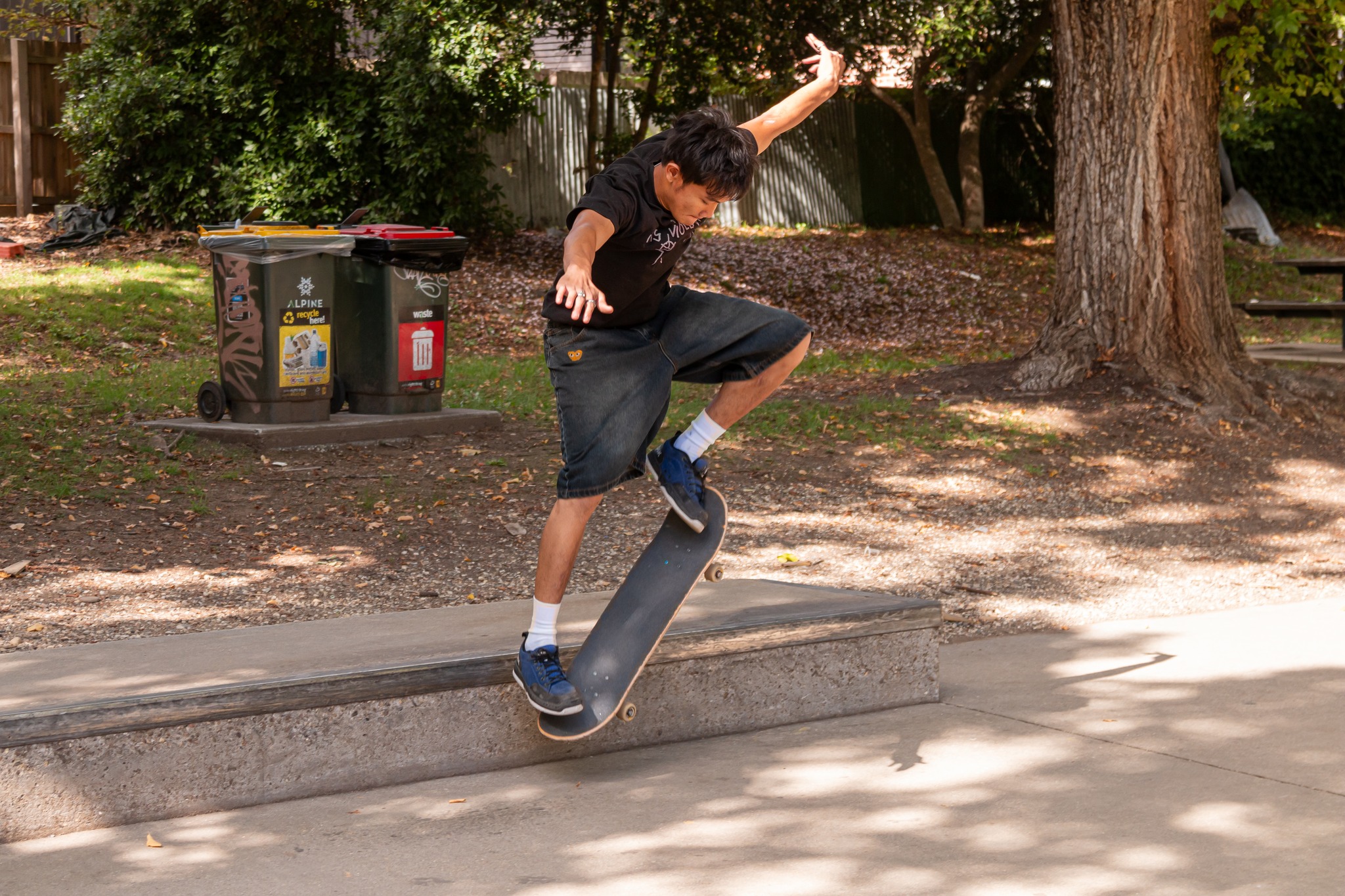 A young person is doing a trick on a skateboard.