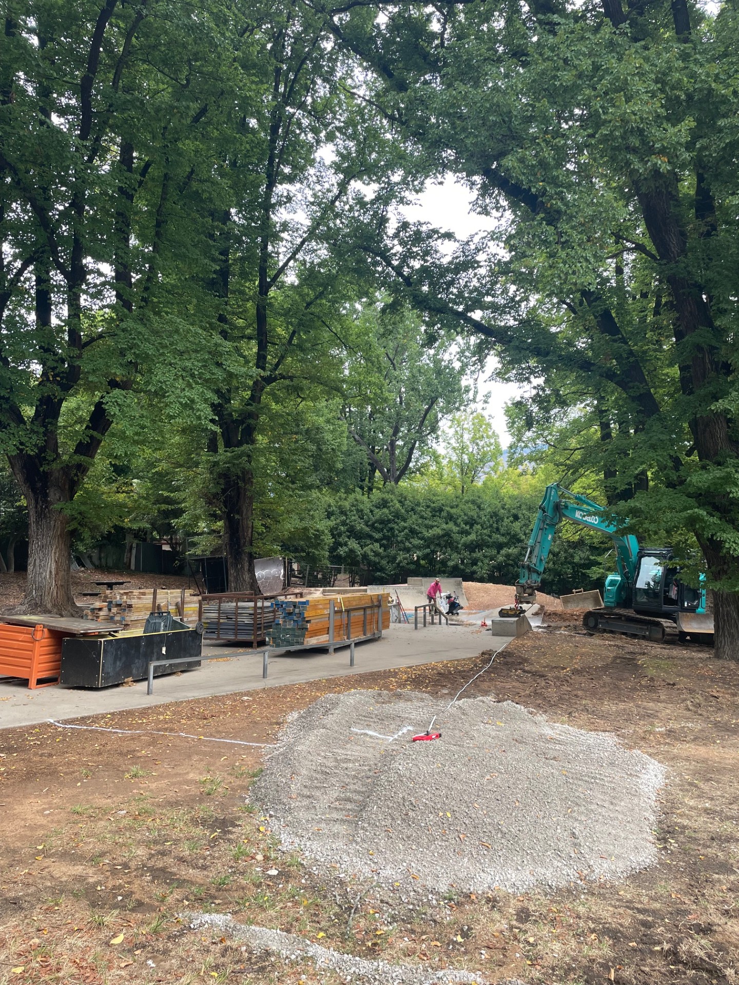 Construction works at a small skate park.