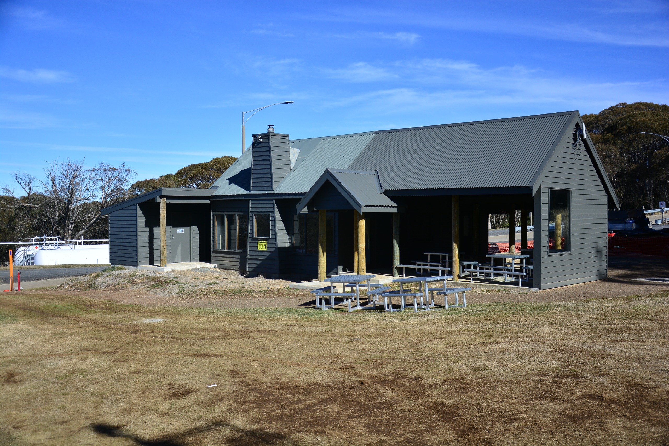​A grey building sitting in front of gum trees.