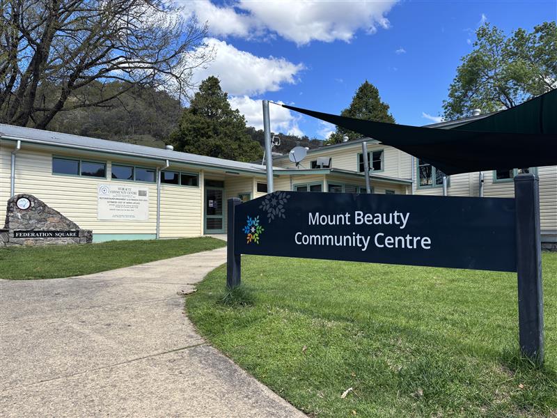 The exterior of the Mount Beauty Community Centre, a white weatherboard building.